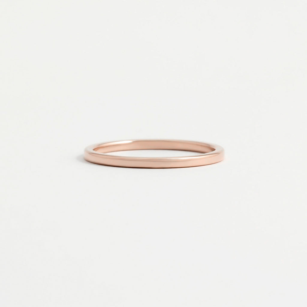 A think, polished rose gold wedding ring.