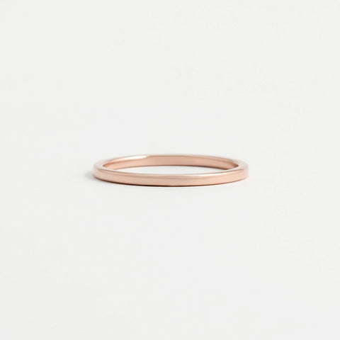 A think, polished rose gold wedding ring.